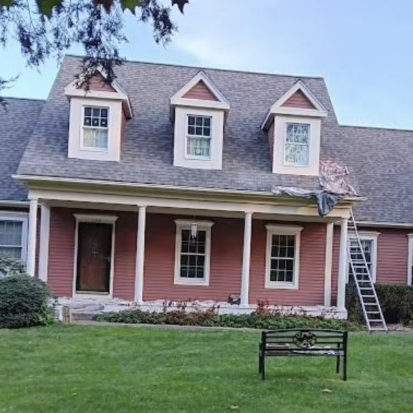 A contemporary cape style home almost done in red.