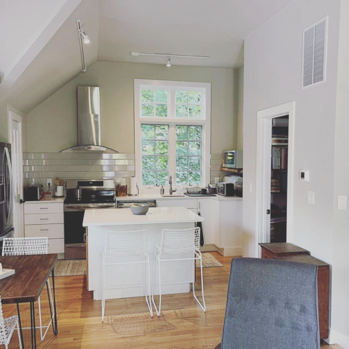 Updated white kitchen. Beige accent wall.