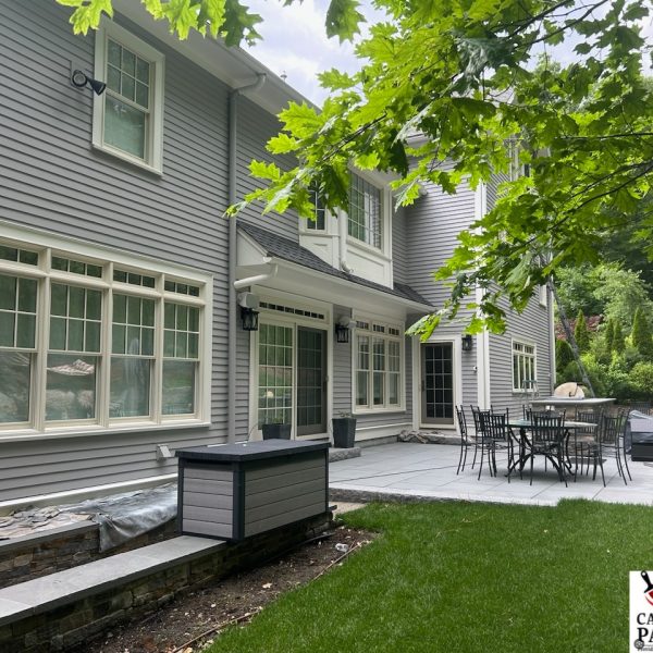 Back of contemporary colonial home finished with an off blue/grey.